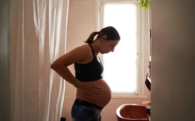 A pregnant woman in her bathroom