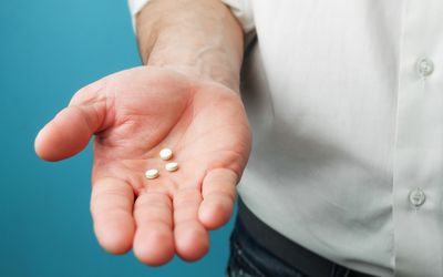 Man holding pills 